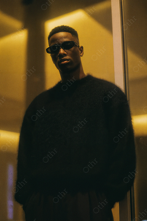 Man in Black Sweater and Sunglasses Under Yellow Light
