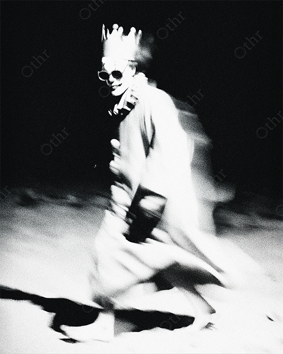 Blurry Clown Wearing Crown and Robe Walking Through Dark Space in High-Contrast Monochrome