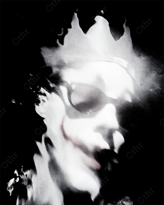 Distorted Clown Wearing Crown and Sunglasses in Abstract Light with Smudged Smile – Monochrome