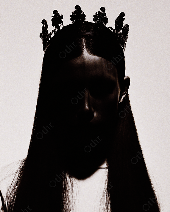 Dark Silhouette of Woman with Ornate Crown and Long Hair Against Pale Gradient Background