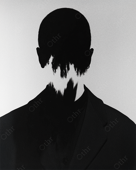 Back View of Headless Silhouette in Suit with Abstract Tear Effect – Monochrome