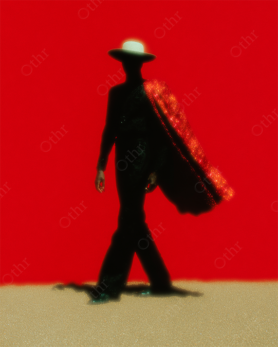 Silhouetted Figure in Wide-Brim Hat with Sparkling Red Cape Walking on Sand Against Red Backdrop