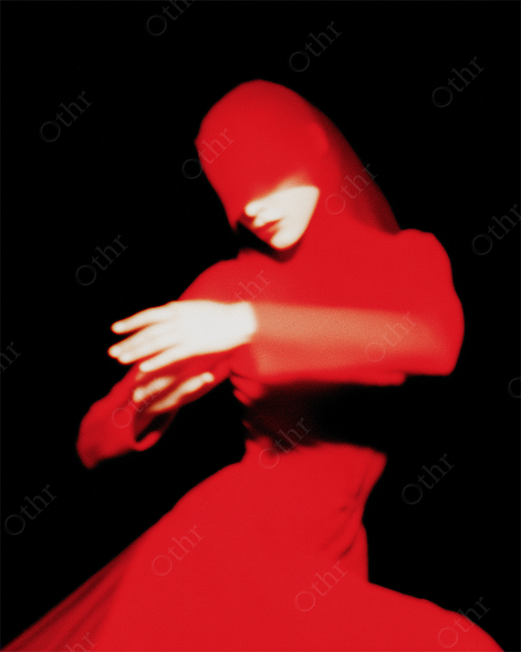 Blurred Figure in Flowing Red Dress with Covered Face Against Black Background – Surreal Motion