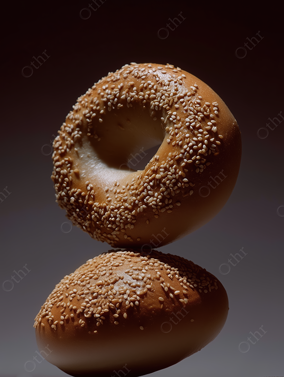 Stacked Sesame Seed Bagels on Dark Gradient Background