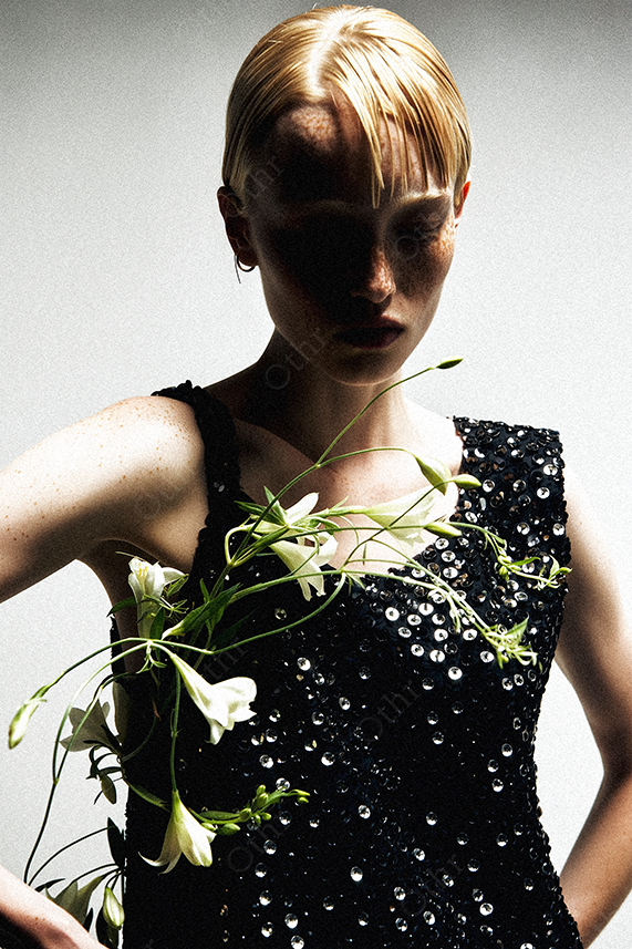 Fashion Portrait of a Person in Sequin Dress With White Lilies Against Gradient Background