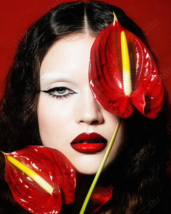 Close-Up Portrait of a Person With Red Anthurium Flowers Against Red Background