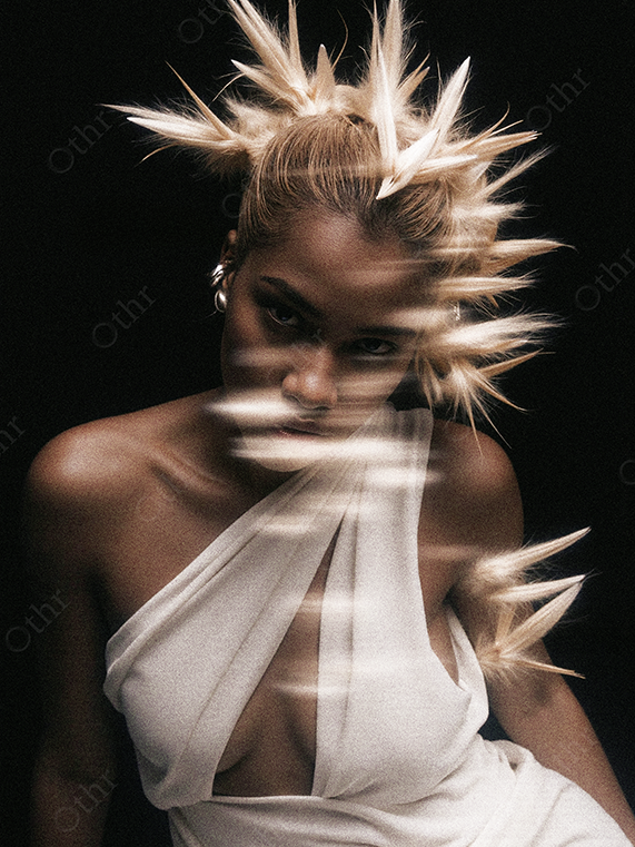 Studio Portrait of a Person in White Dress With Spiked Blonde Hair and Motion Blur