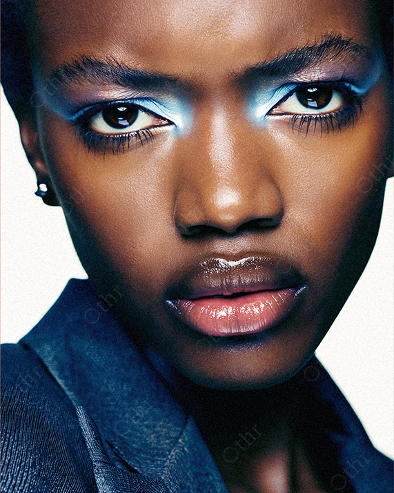 Close-Up Portrait of a Person With Glossy Lips and Blue Eyeshadow