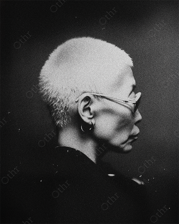 Grainy Black and White Profile Portrait of Person With Short Hair and Glasses