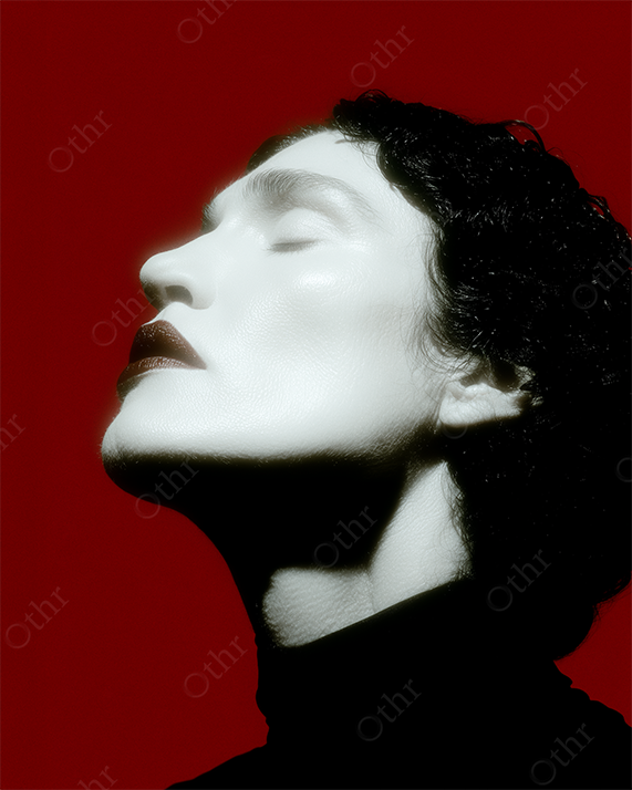 Close-Up Portrait of Person With Pale Skin and Dark Lips Against Red Background