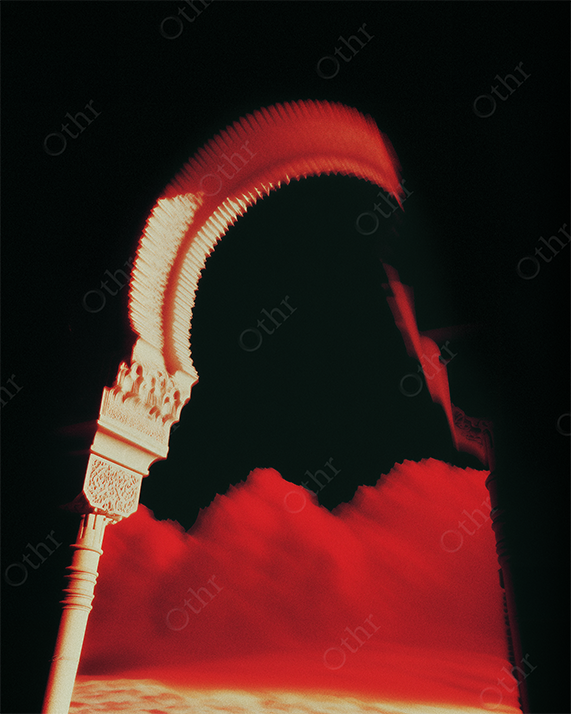 Blurred Ornamental Archway Overlooking Red Clouds and Dark Sky