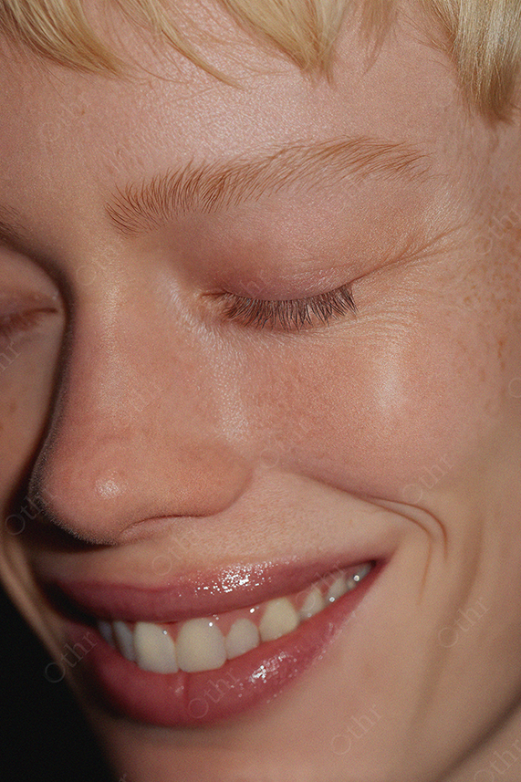 Close-Up of Smiling Person With Eyes Closed and Glossy Lips
