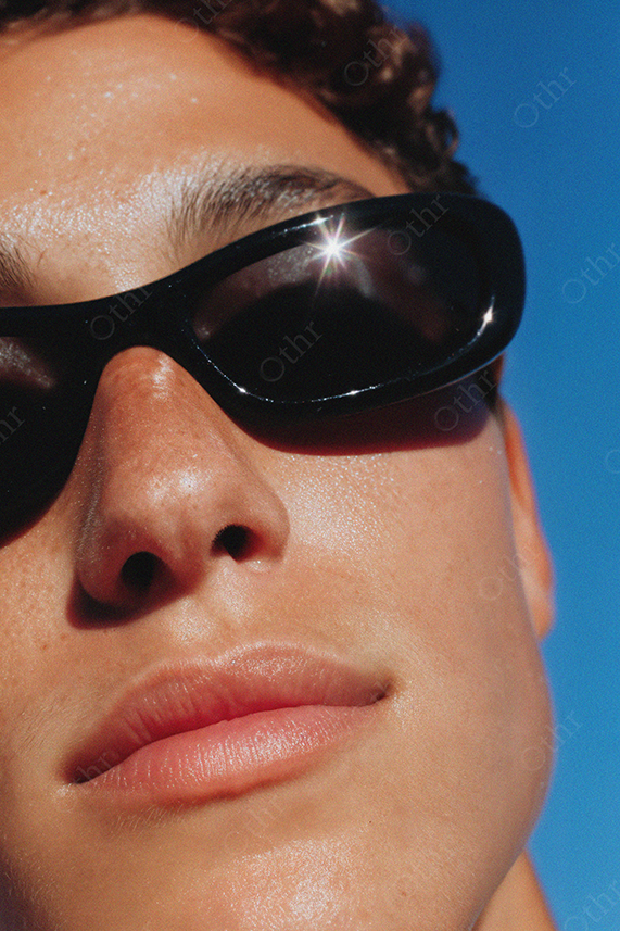 Close-Up Portrait of Man Wearing Black Sunglasses in Sunlight