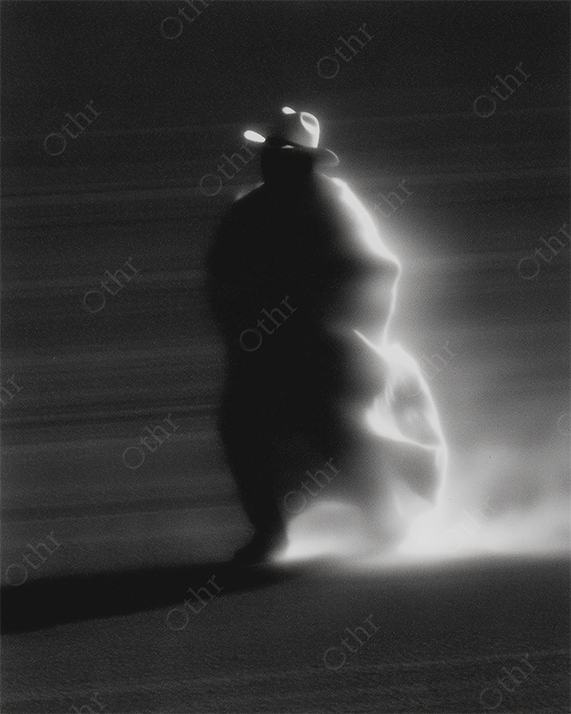 Monochrome Backlit Drifter in Desert Wearing Wide-Brim Hat