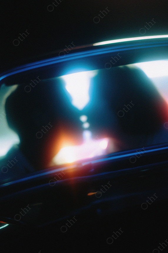 Couple Kissing Through Car Window at Night.