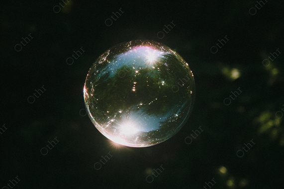 Bubble floating against dark background with iridescent reflection.