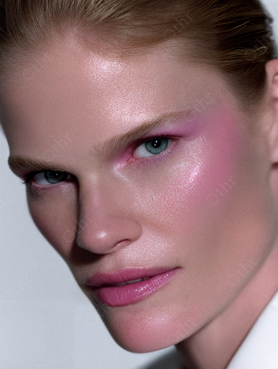 Close up portrait of a person with pink makeup and lips.