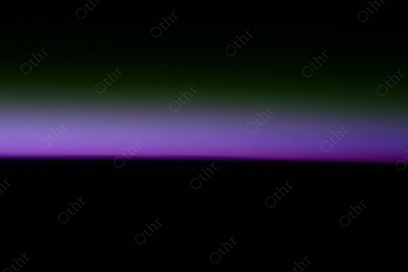 Gradient twilight sky — deep black horizon fading into violet, lavender and forest green sky.