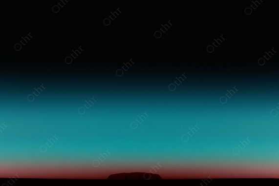 Uluru under a cyan-red gradient sky.