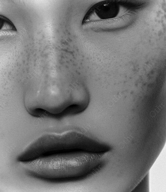 Monochrome Close-Up Portrait of a Woman with Freckles.