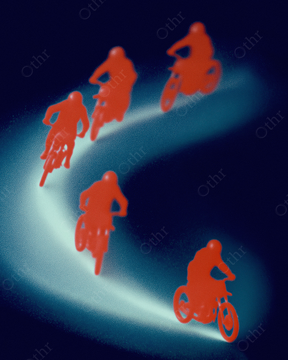 Red Motorcyclists driving on a hazy blue road.