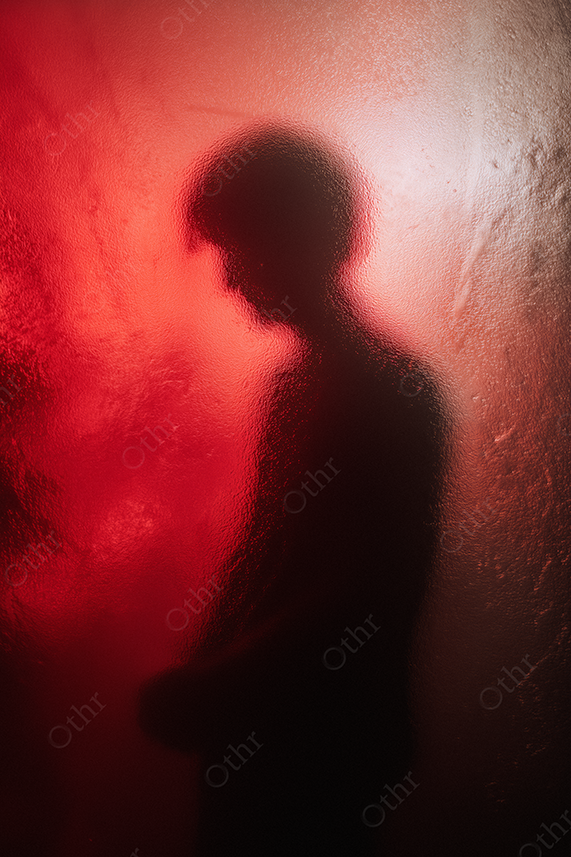 Silhouette of a person with red lighting