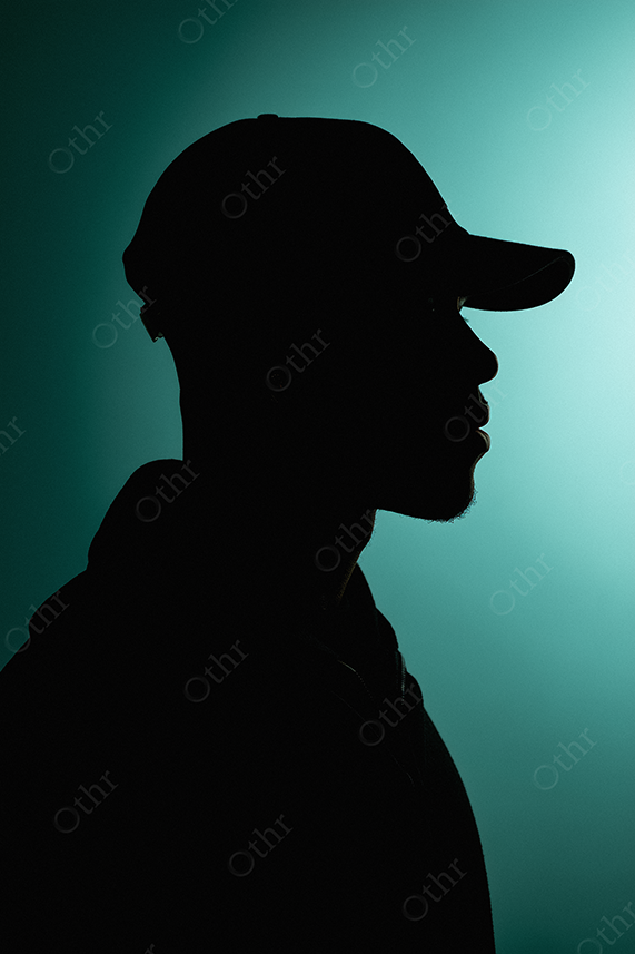 Moody silhouette of figure on a teal background
