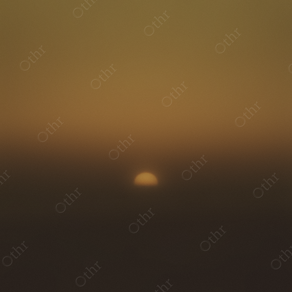 Grainy Sunset Over Horizon in Golden Haze
