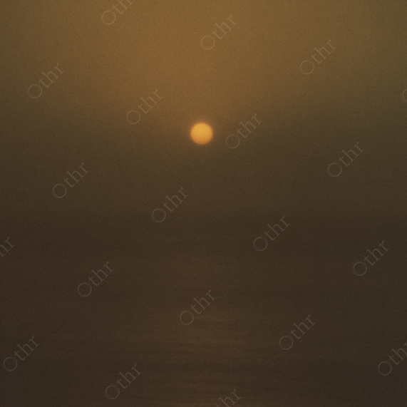 Grainy Sunset Over Horizon in Golden Haze