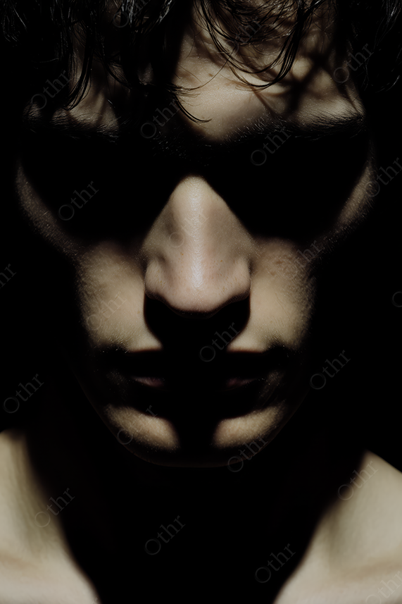 Person’s Face Emerging From Deep Shadow