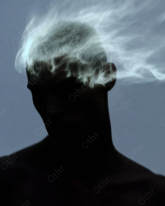 Silhouette of Person with White Flame Burning Across Head