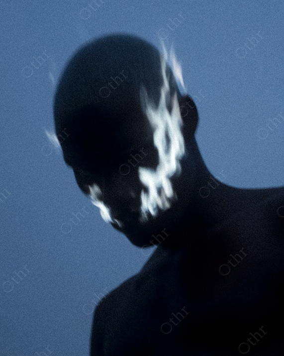 Shadowed Man with Blue Flame Markings on Face