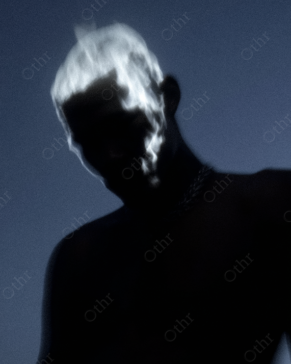 Dark Silhouette of Person With White Flame Effects on Hair and Face
