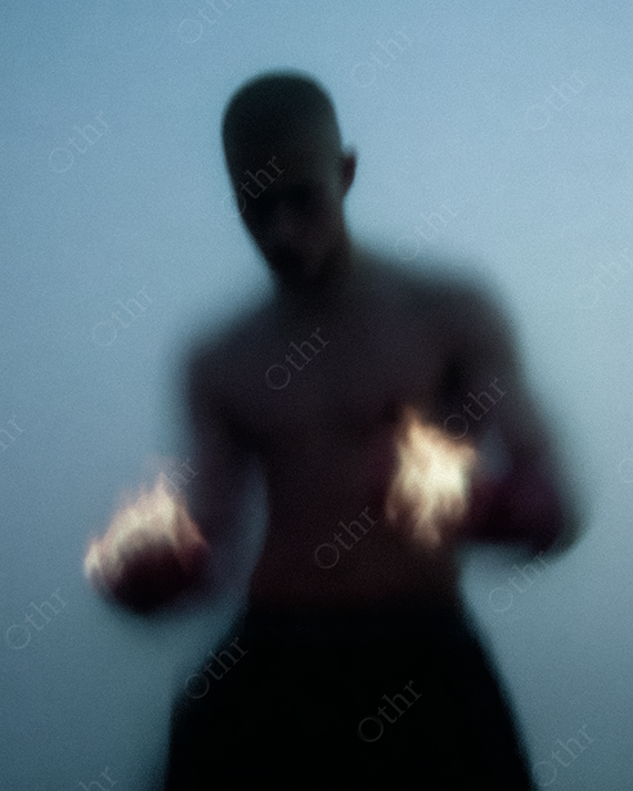 Blurry Shirtless Person Holding Flames in Both Hands at Dusk