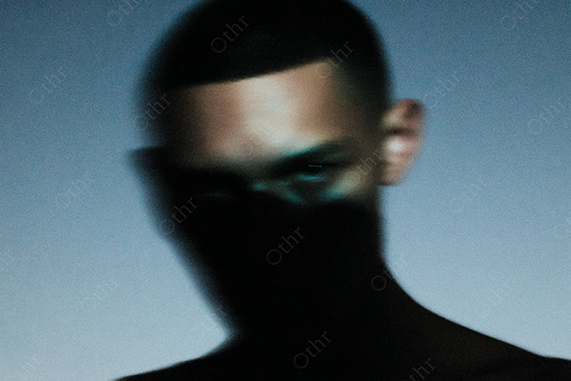 Blurry Close-Up of Person with Shadowed Lower Face Against Blue Gradient