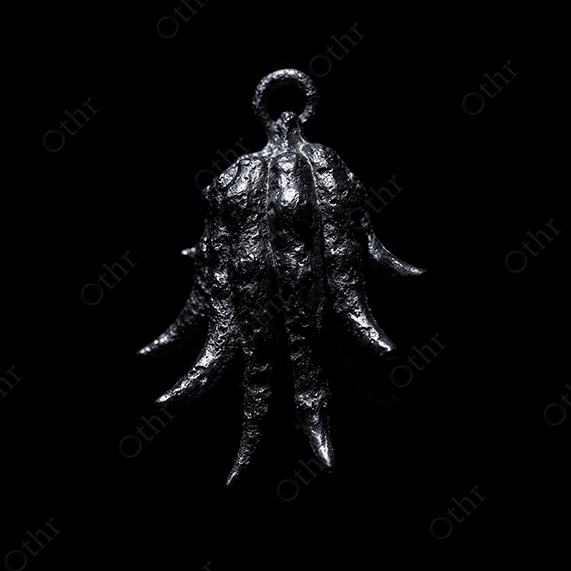 Metallic Citrus Hand Pendant on Black Background – Still Life