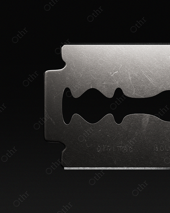 Close-Up of Single Razor Blade Against Dark Background – Still Life