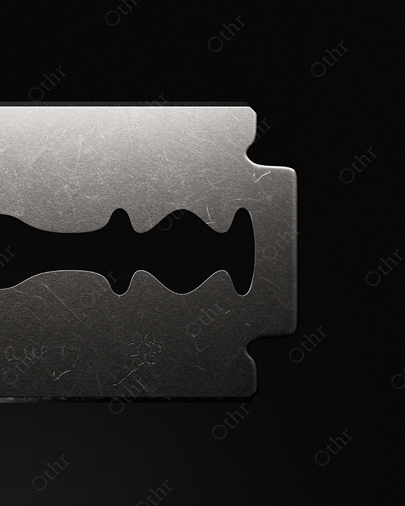 Close-Up of Single Razor Blade Against Dark Background – Still Life