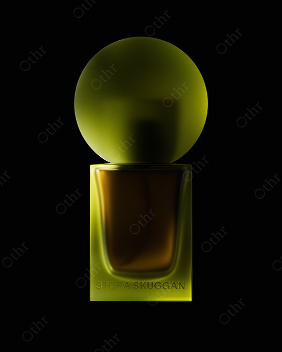 Green Glass Perfume Bottle With Spherical Cap on Black Background – Studio Still Life