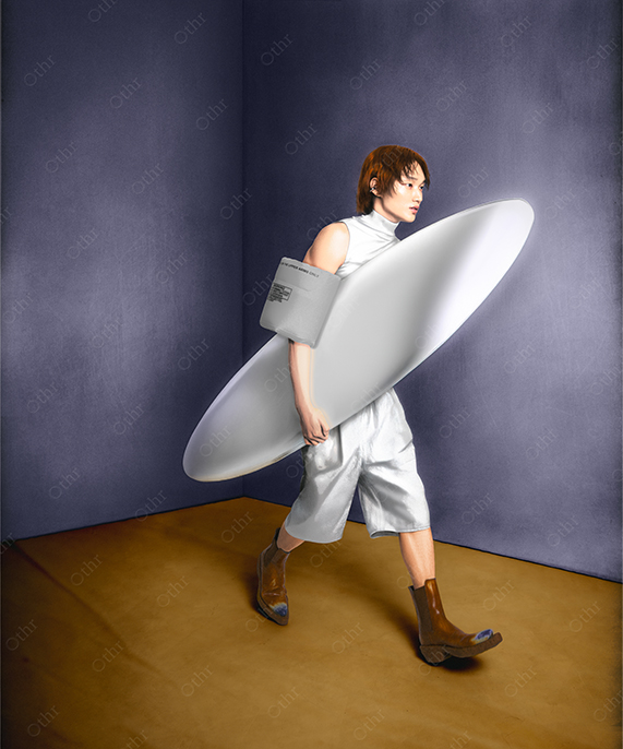 Person in Metallic Silver Outfit Carrying Large White Oval Object in Minimalist Room