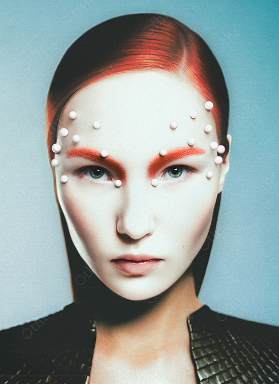 Close-Up Portrait of Woman With Red Hair and White Beads on Face Against Blue Background