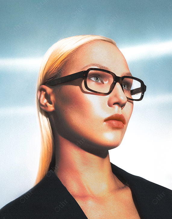 Portrait of Woman With Blonde Hair and Black Glasses Looking Up Against Blue Gradient Background