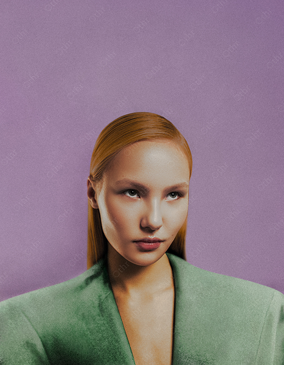 Portrait of Woman With Red Hair Wearing Green Blazer Against Purple Background