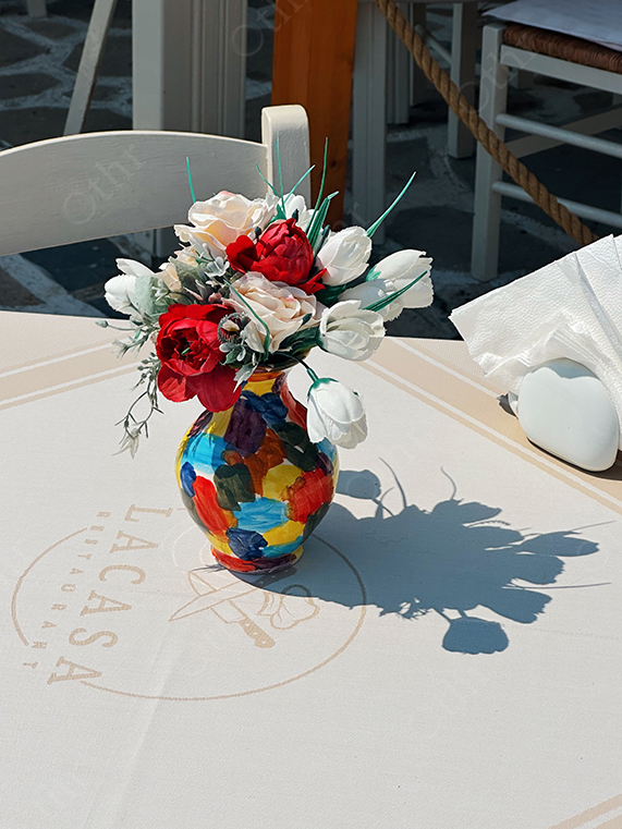 Colourful Vase With Red and White Flowers on Restaurant Table
