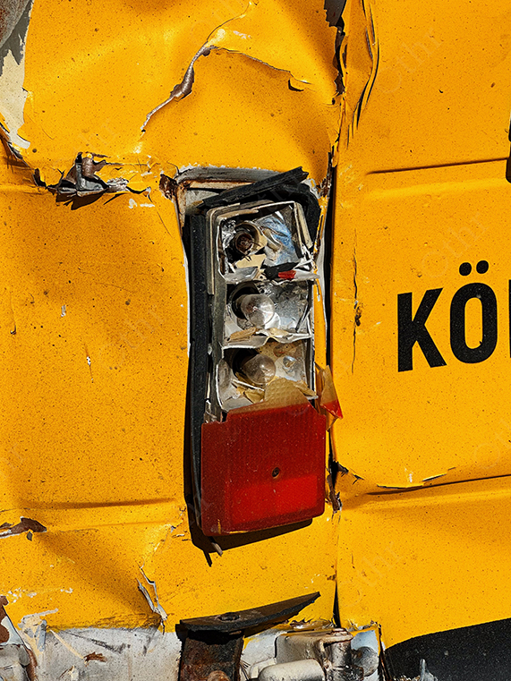 Broken Tail Light on Damaged Yellow Vehicle