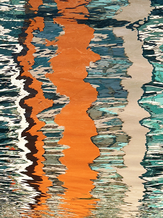 Colourful Building Reflections Distorted on Water Surface