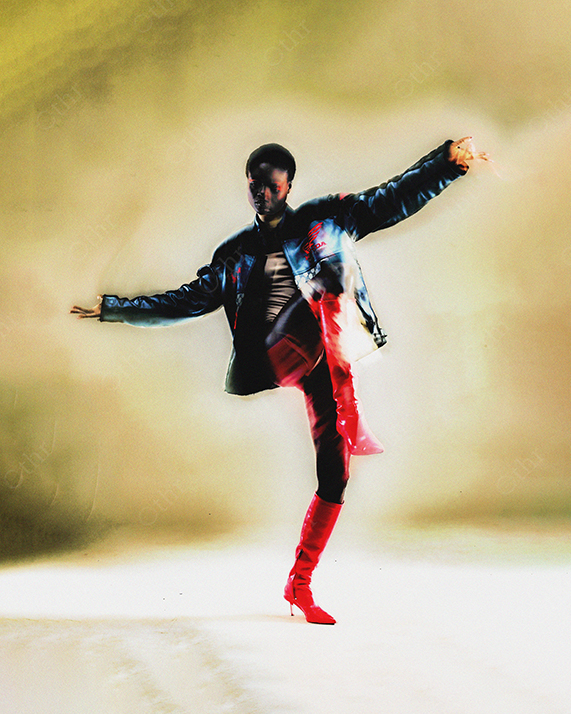 Person in Dynamic Pose Wearing Red Boots Under Soft Golden Light