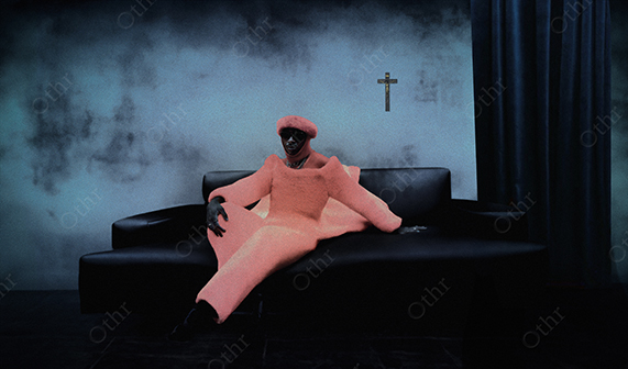 Person in Bright Pink Outfit Reclining on Black Sofa Against Moody Blue Wall With Cross