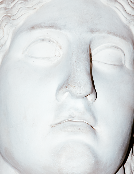 Close-Up of a White Stone Sculpture Face Under Direct Light