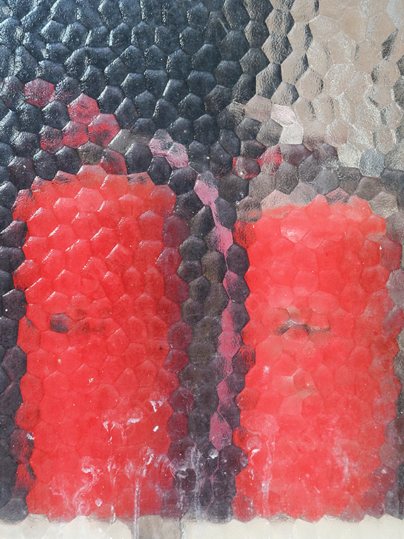 Red Objects Distorted Through Textured Glass Surface